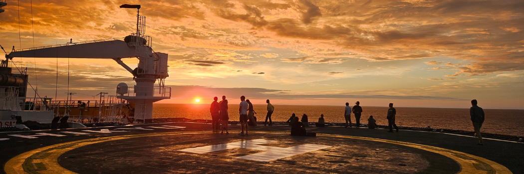 The deck of a large ship at sunset