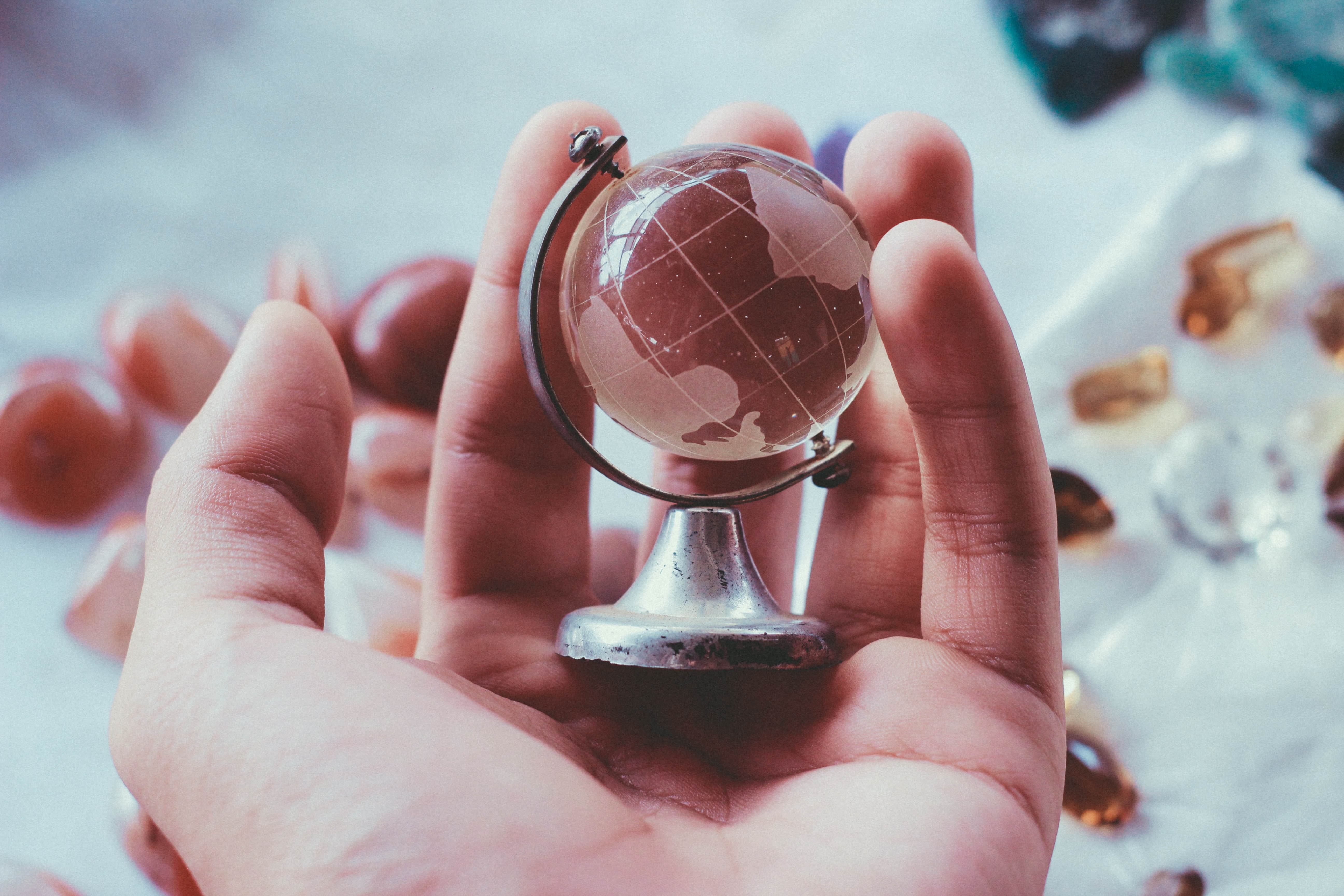 Miniature globe in the palm of a hand