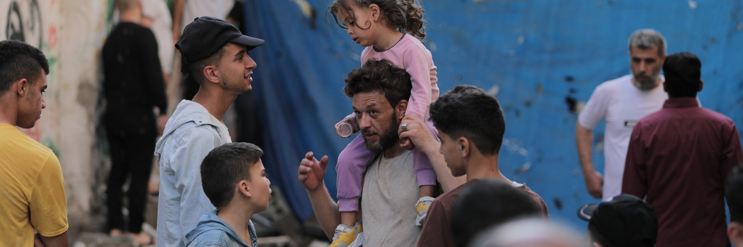 People stand outside in Gaza warzone