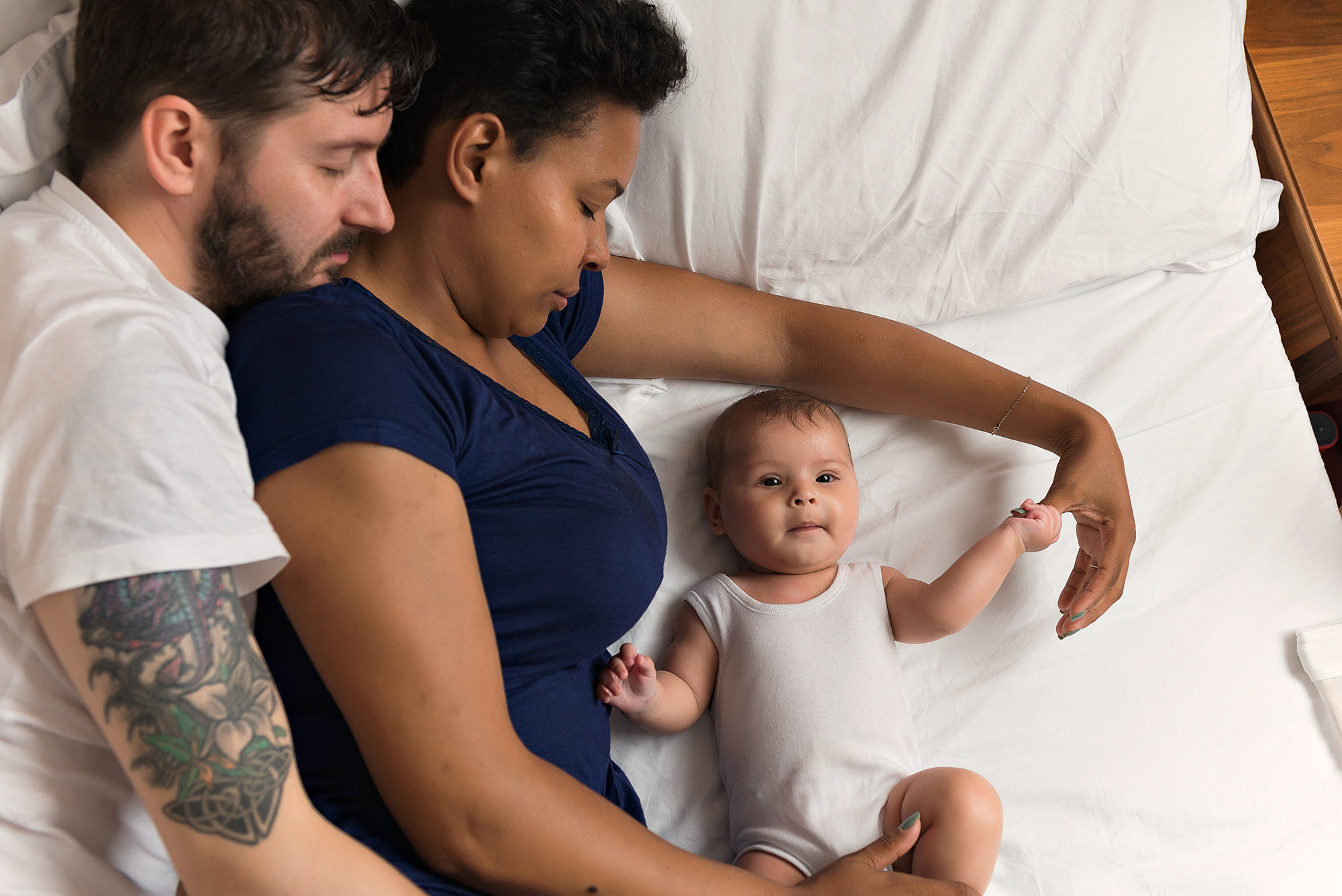 Couple laying down with baby