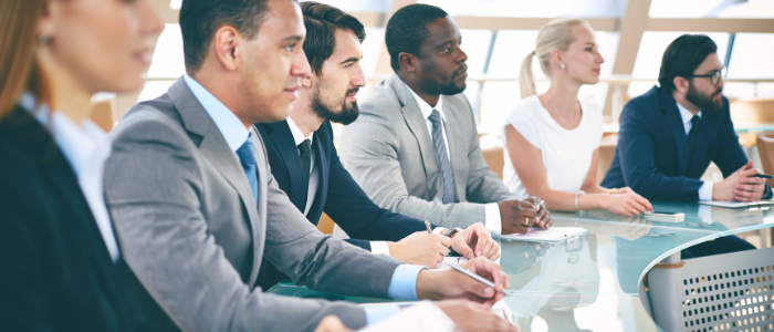 Business students seated at curving desk