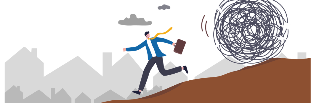 Cartoon of business man running down a hill away from a tumbleweed
