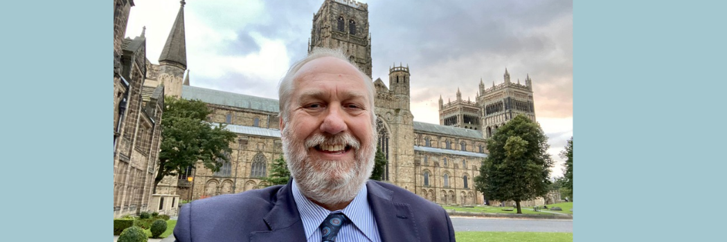 Chris de Jong smiling outside of Durham Cathedral