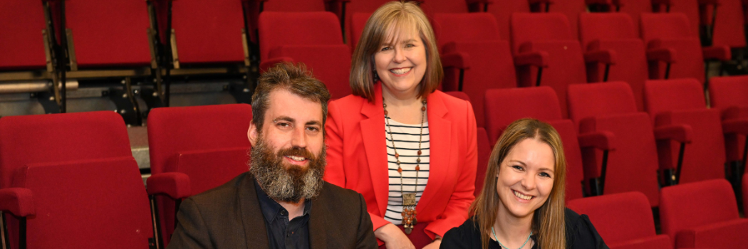 Thomas Pollet, Jamie Callahan and Clare Cook seating in a theatre