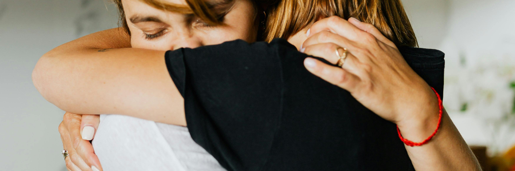 women hugging each other