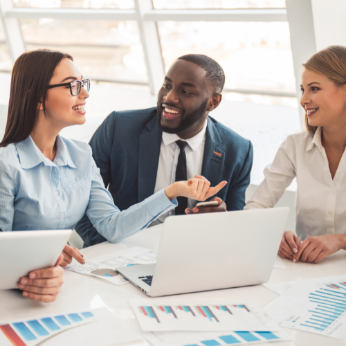 Two female and a male business person discussing finance papers