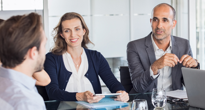 Two men and a woman in a business meeting