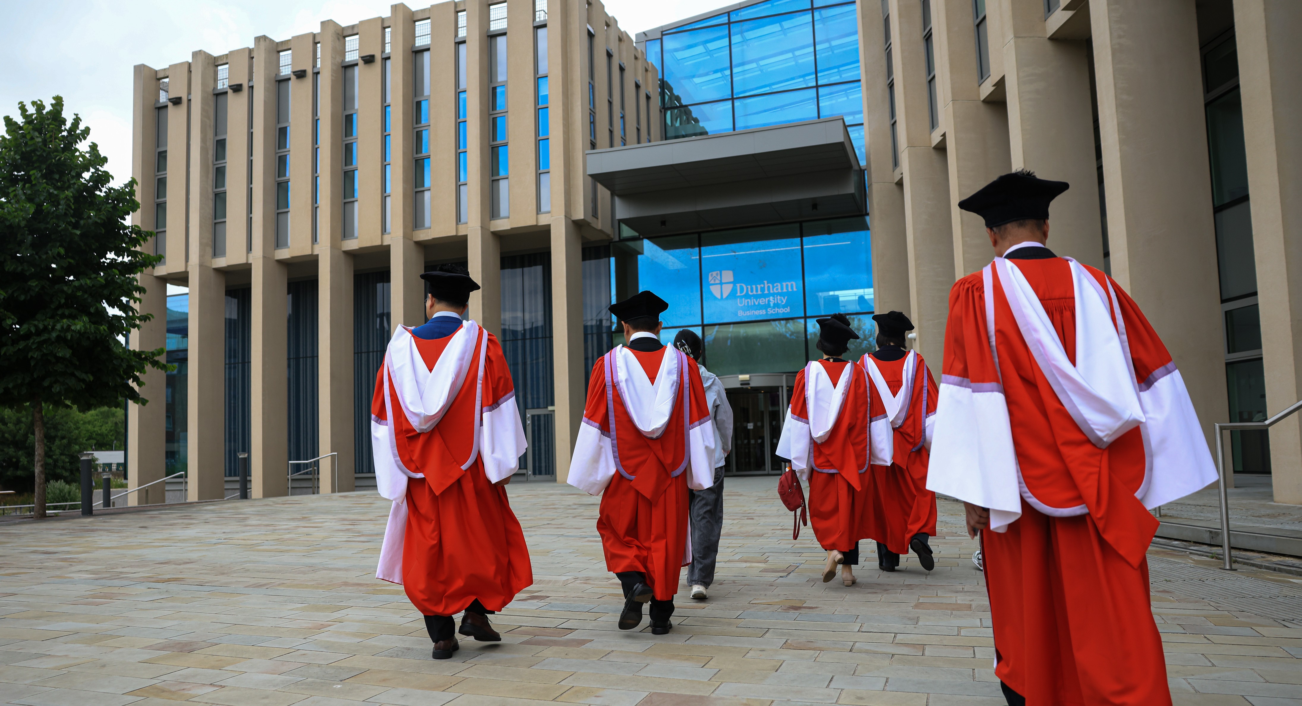 DBA Graduates walking towards business school