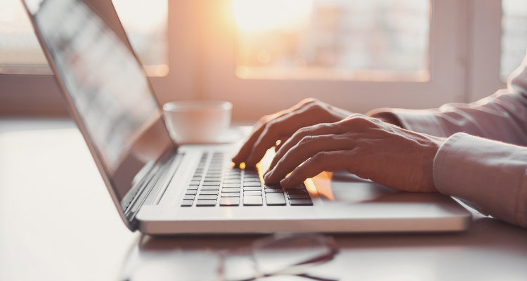 Man hands typing on a laptop