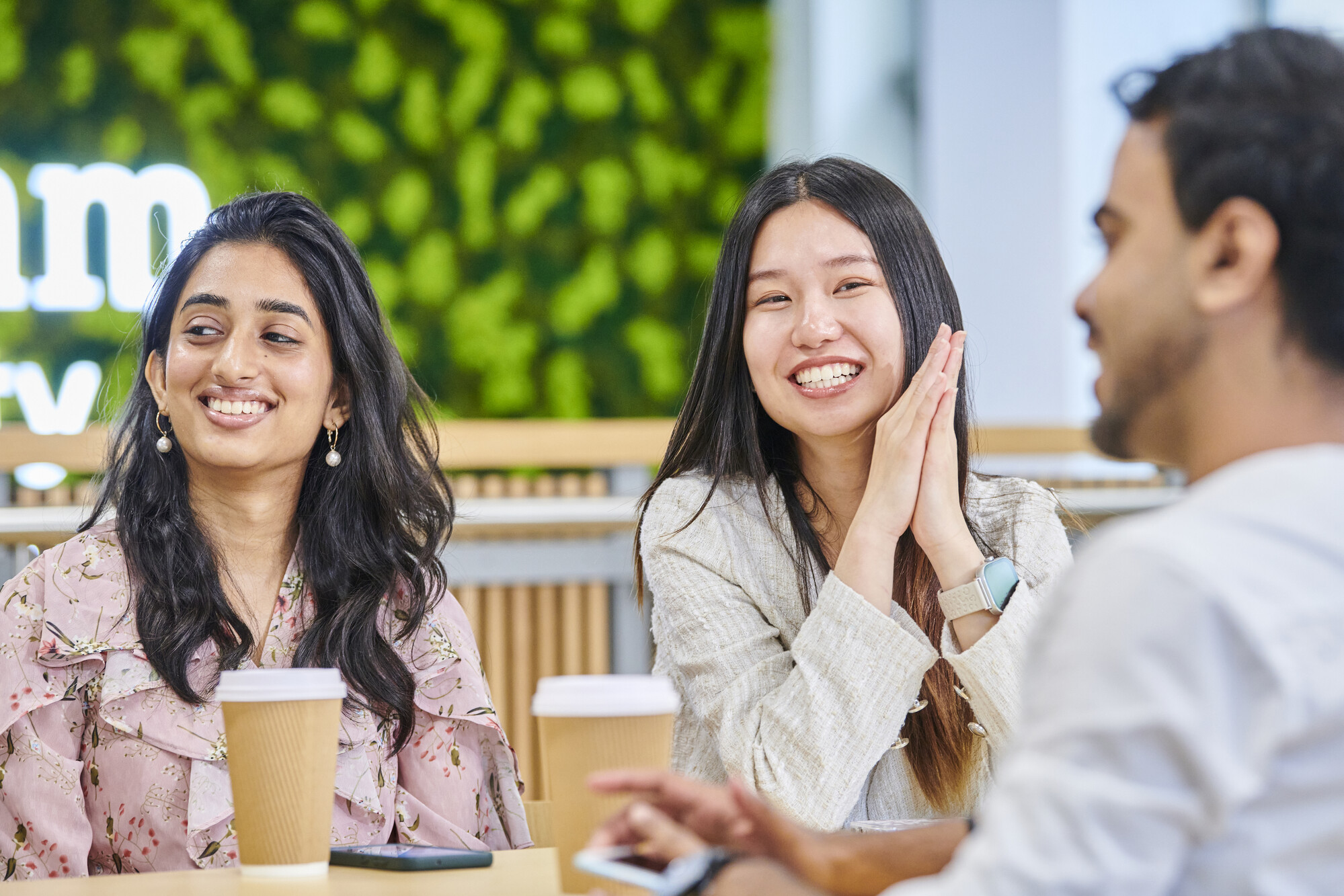 Group of smiling students at the Business School's Waterside building