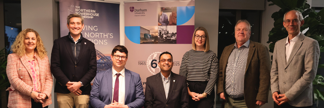 Group of people standing around a table for contract signing
