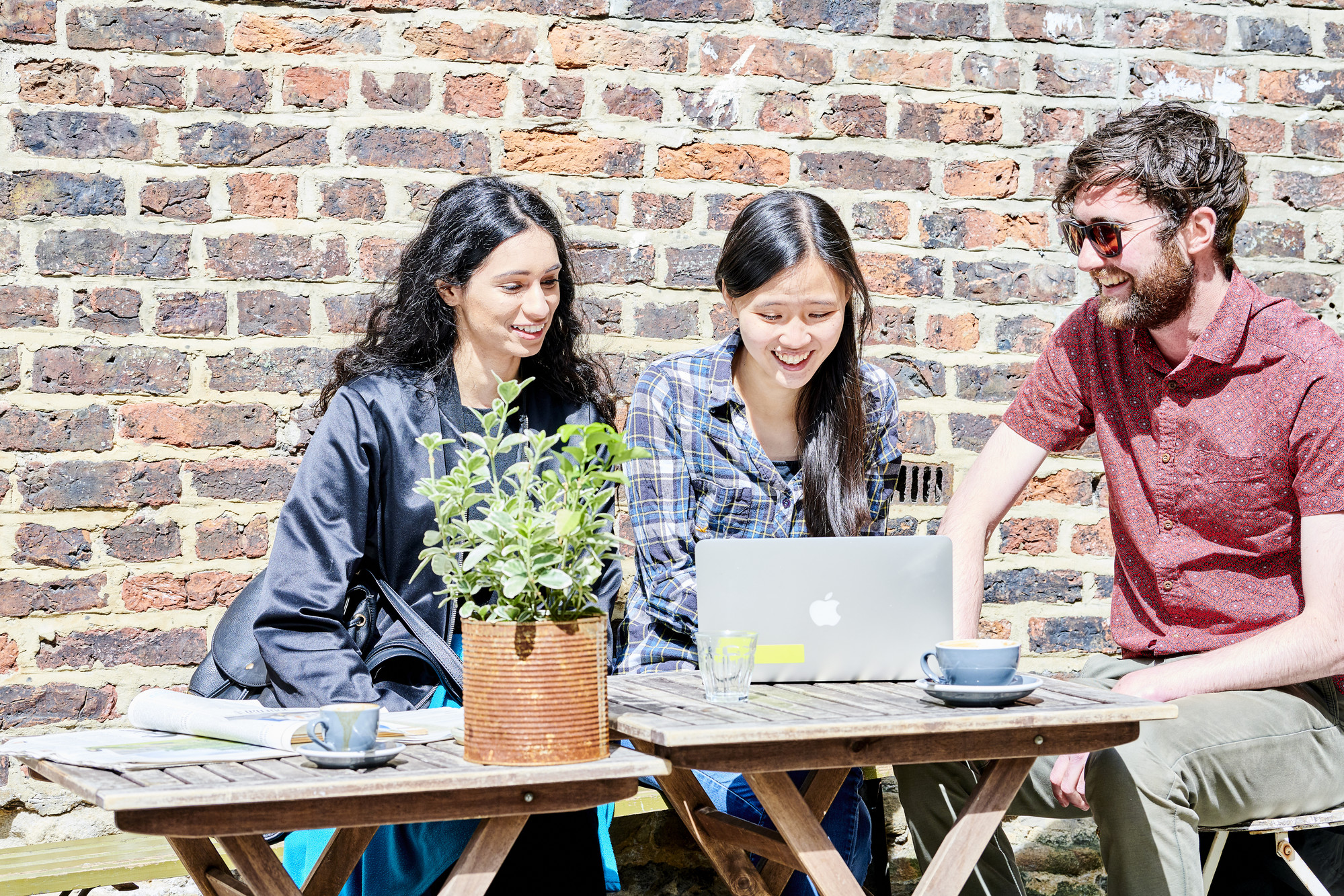 Students studying and drinking coffee outside