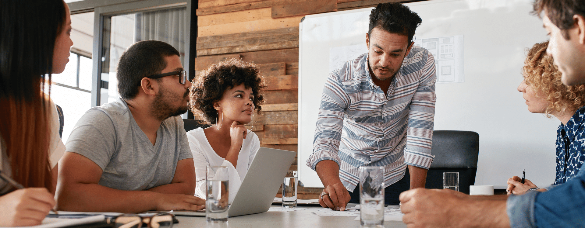 A leader directing a business meeting around a table
