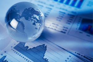 A glass globe sitting on top of financial graphs