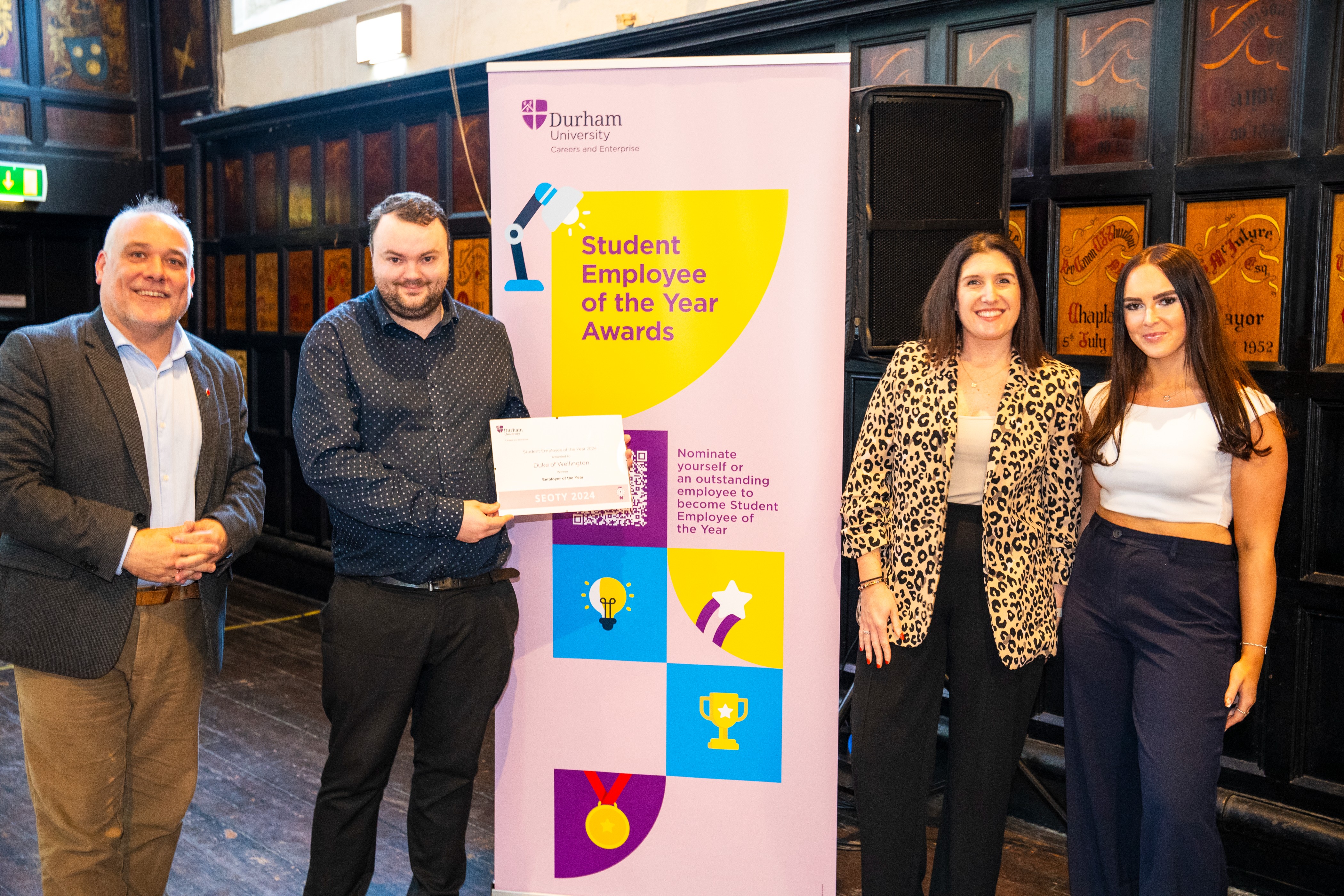 A representative for The Duke of Wellington collects the Employer of the Year Award Off Campus at the SEOTY 2024 square