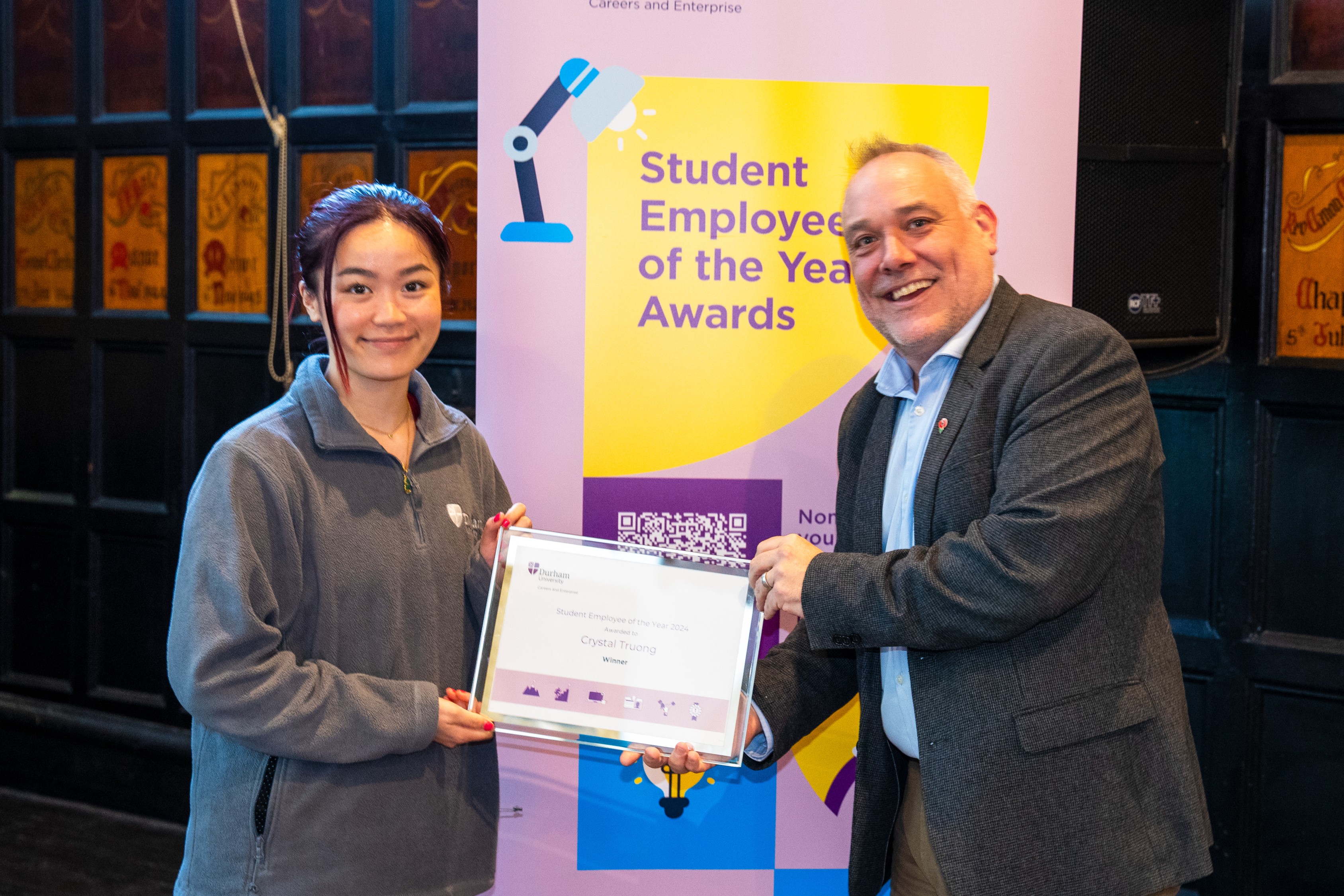 Crystal Truong collecting the Overall Student Employee of the Year Award at the Student Employee of the Year Awards 2024