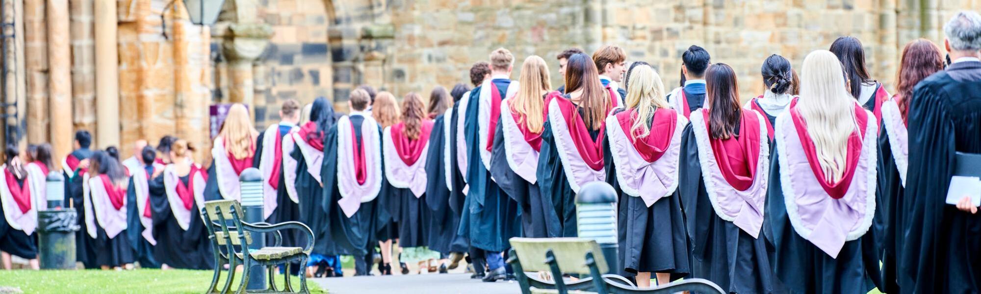 Students in academic gown processing into the cathedral