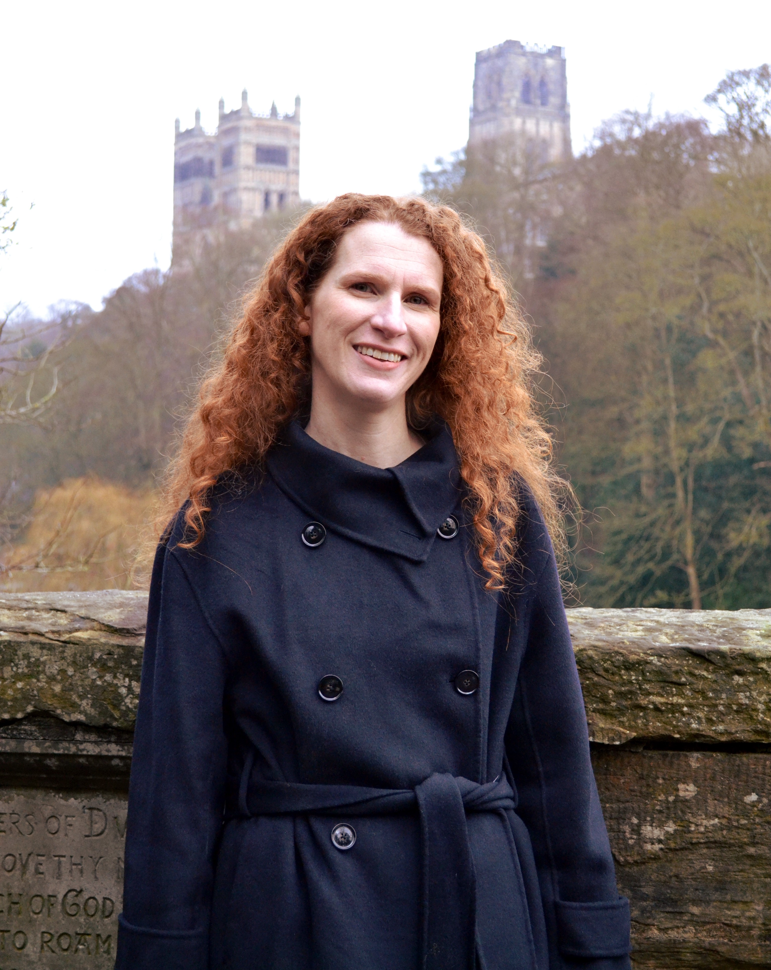 Louise McLaren stand on the Prebend Bridge, with views towards Durham Cathedral