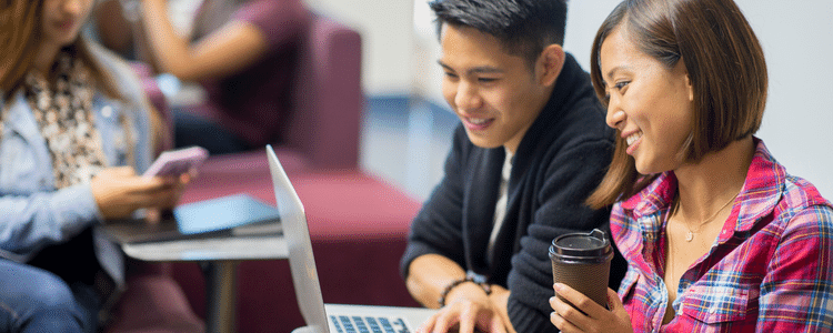 Two students looking at a laptop