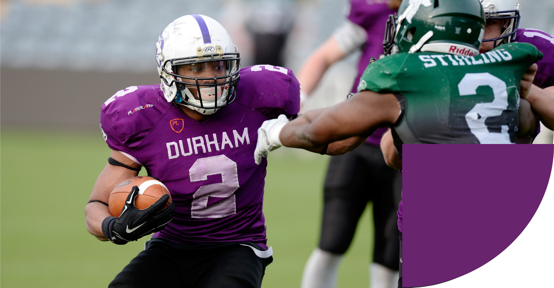 Students wearing green and purple playing American football