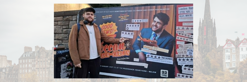 Bróccán Tyzack-Carlin in front of his publicity poster at the Edinburgh Fringe