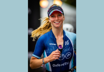 Grace Gilbert running in a triathlon smiling at the camera