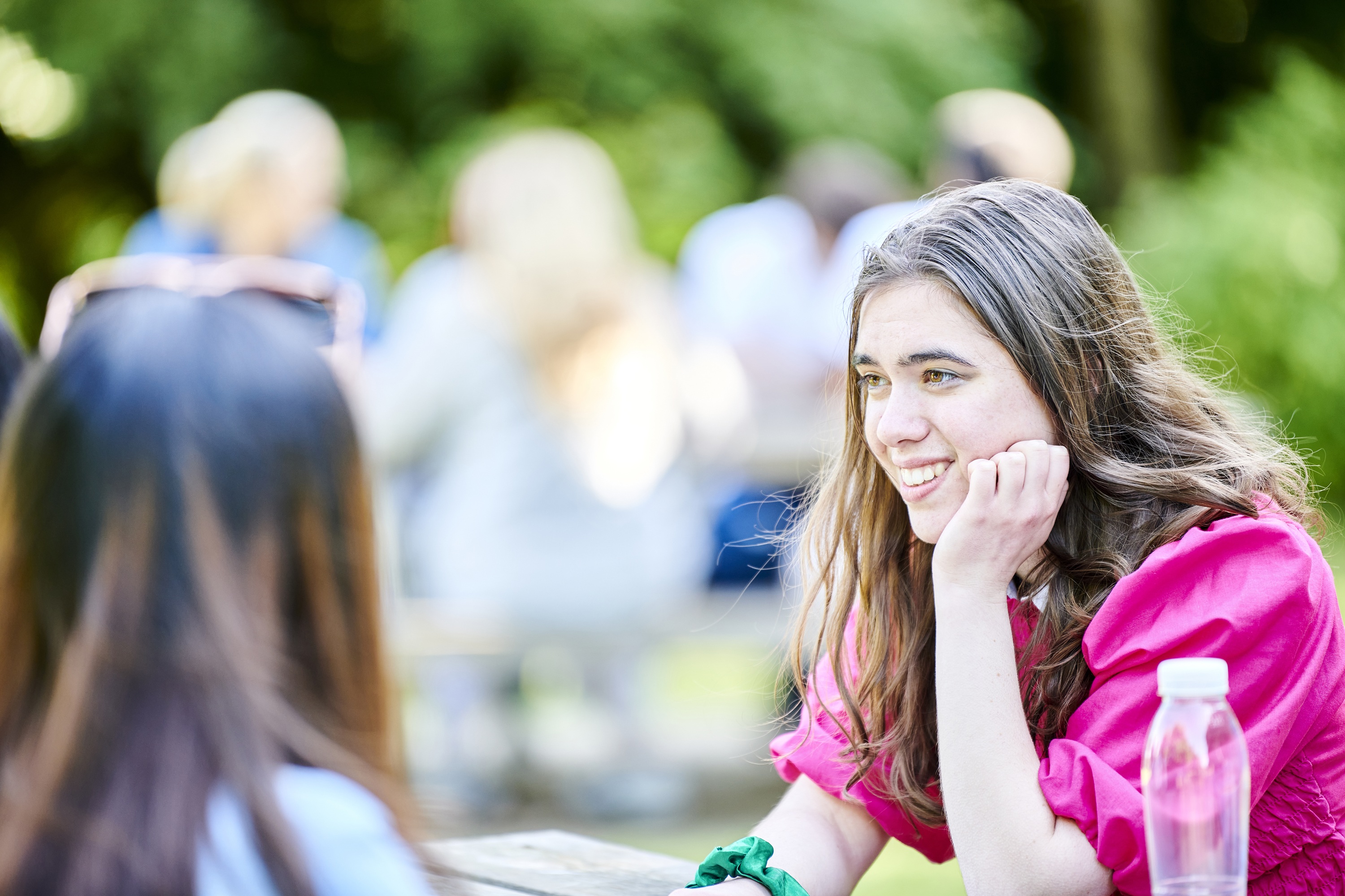 a young girl wearing a pink shirt