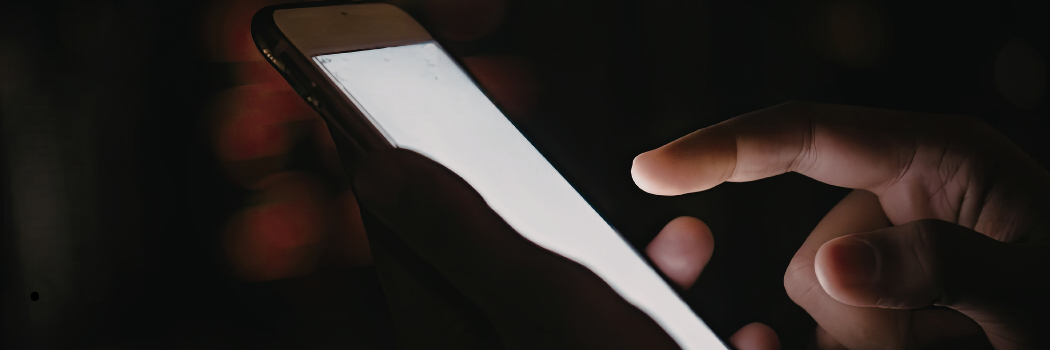 Someone scrolling on a mobile phone.