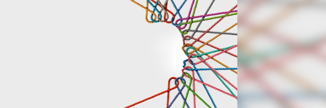 Grey background with different coloured ropes forming the outline of a human head and neck in profile