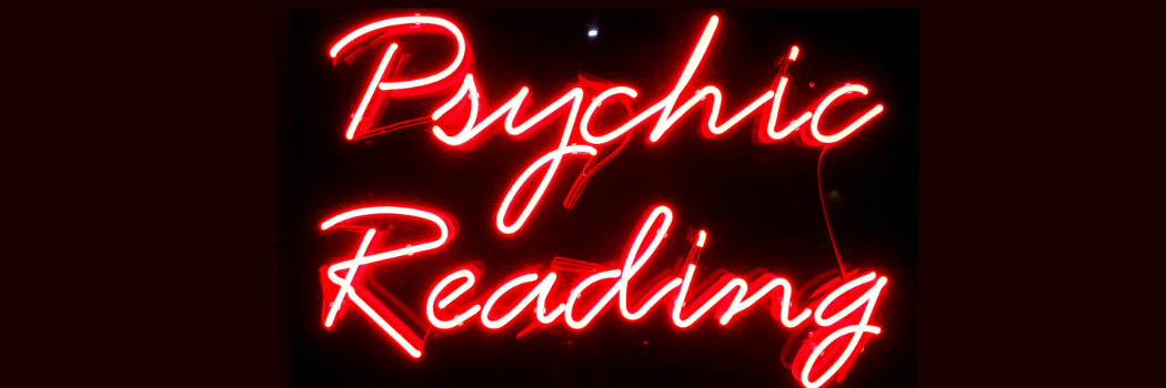 Red neon with the words psychic readings, on a black background