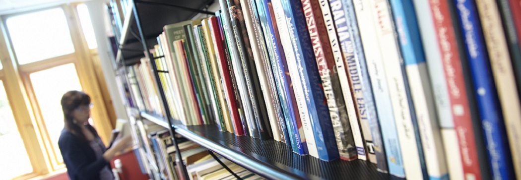 Person browsing books in a library