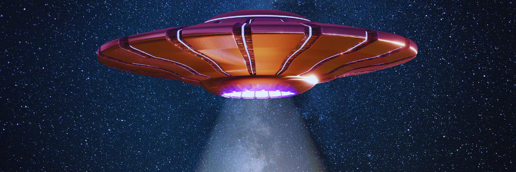 A UFO floats against the night sky with its tractor beam lit