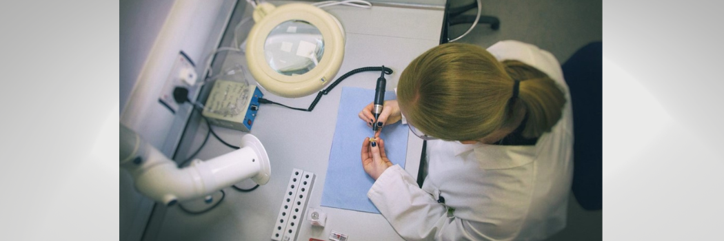 A female researcher examining a Roman tooth in a laboratory