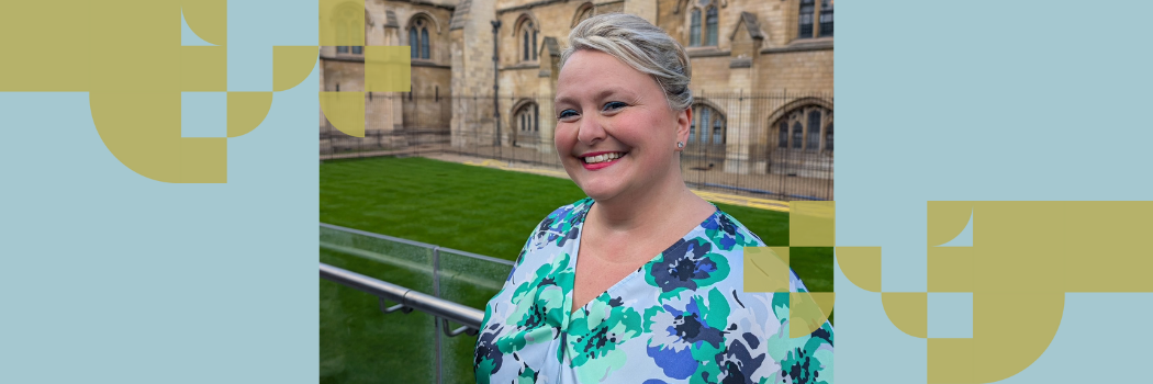 Arlene Holmes-Henderson stood outdoors, smiling wearing a blue top.