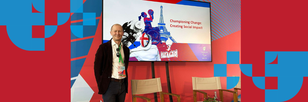 Prof Brett Smith smiling in front of a screen