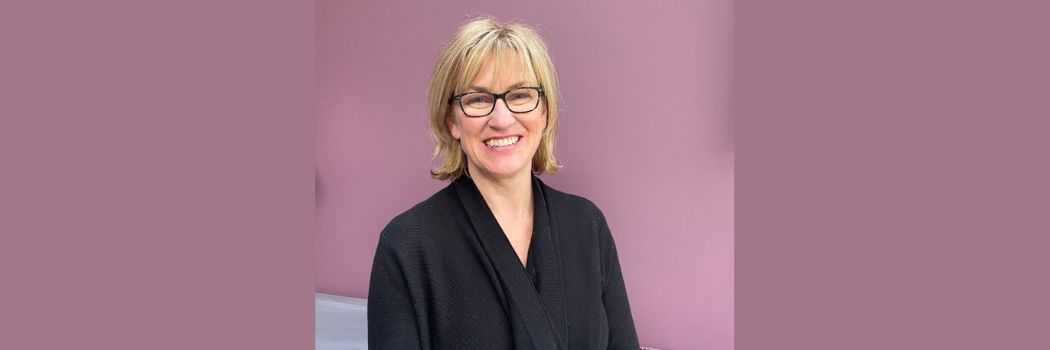 A picture of Professor Clare McGlynn against a pink/purple backdrop