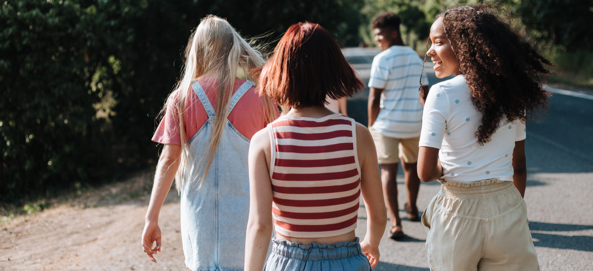 A group of children walking away from the camera