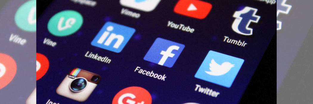 A close up of social media app icons on a phone.