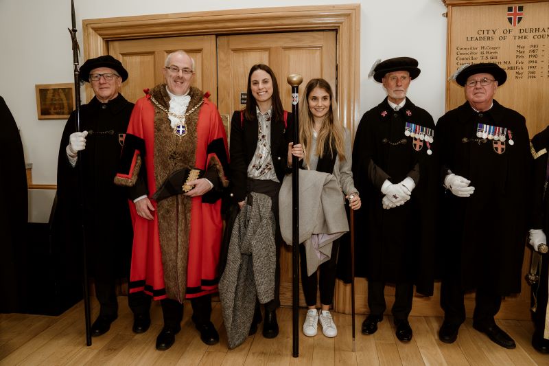 The Mayor and some of his bodyguard standing with some students