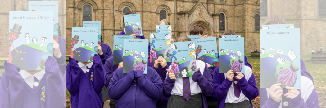 School children stood in front of Durham Cathedral holding books in front of their faces