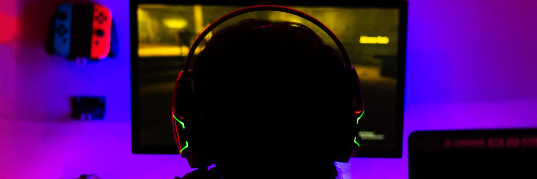 A man wearing a headset playing a video game