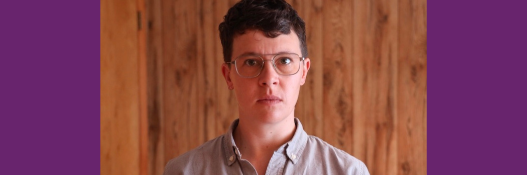 A portrait of Dr Joan Lubin standing in front of wood paneling