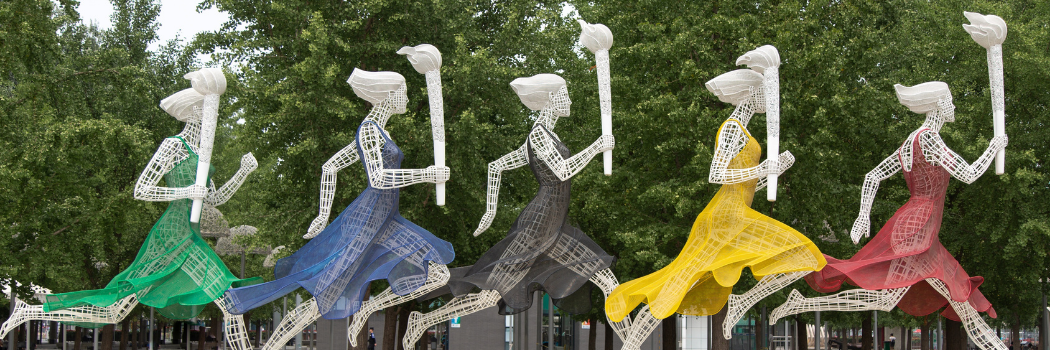 Statue of women running with olympic torches in beijing