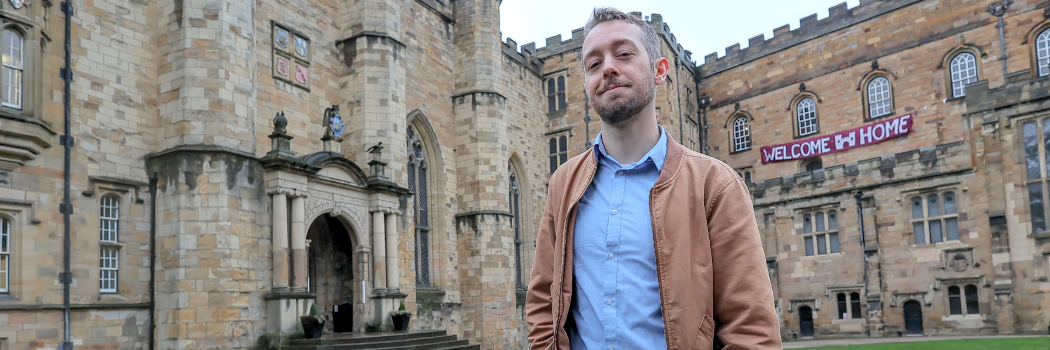 Waylon Cunningham standing in the courtyard of Castle College