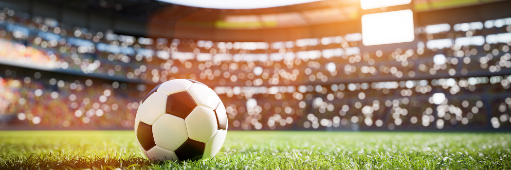 Football on pitch in arena