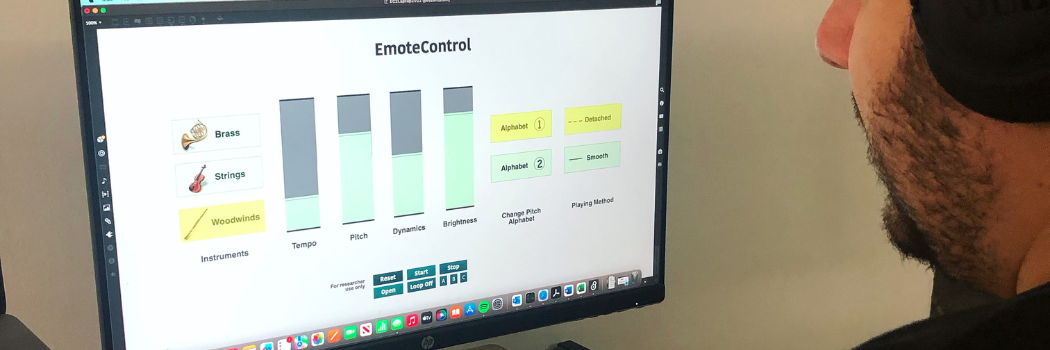 A person sitting at a laptop displaying the Emote Control programme