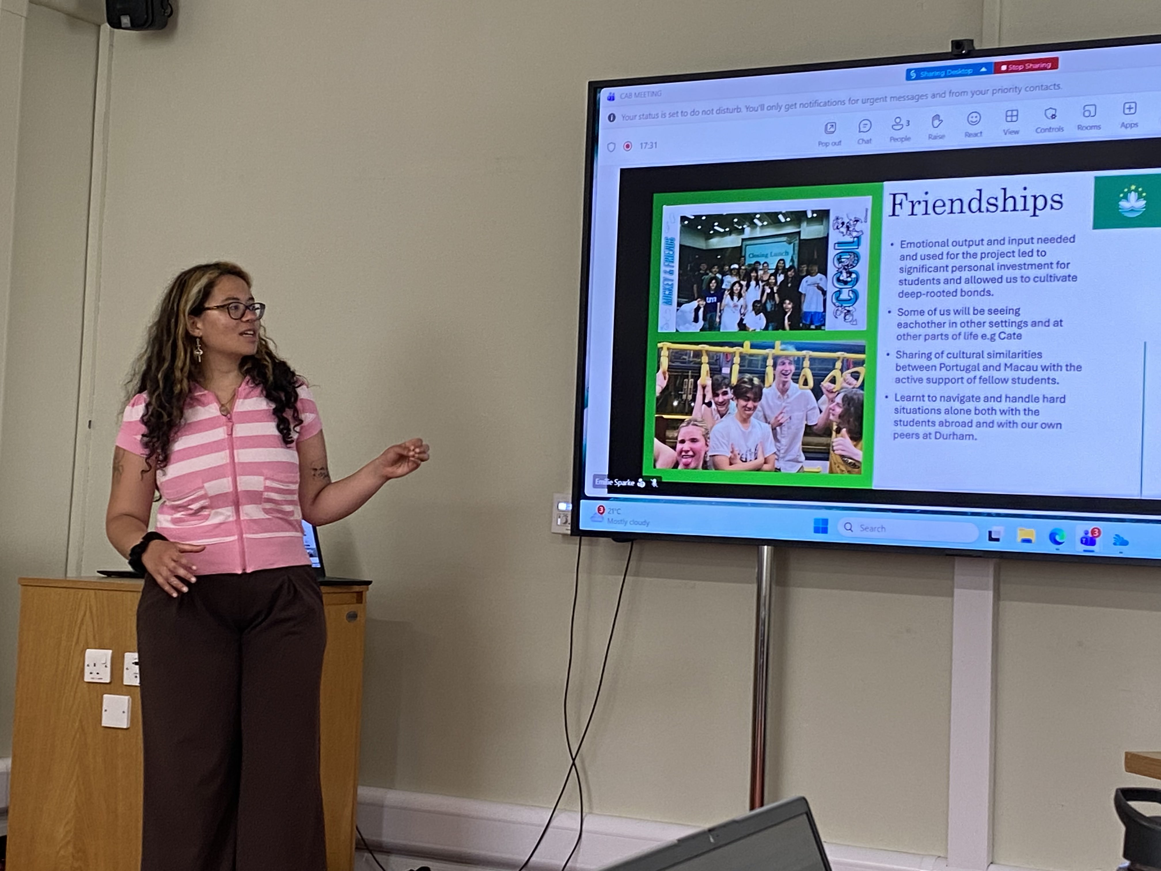 Grey student giving a presentation about exchange programme