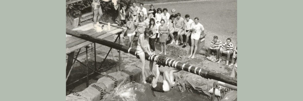 Black and white archive photo of female students on a greasy pole