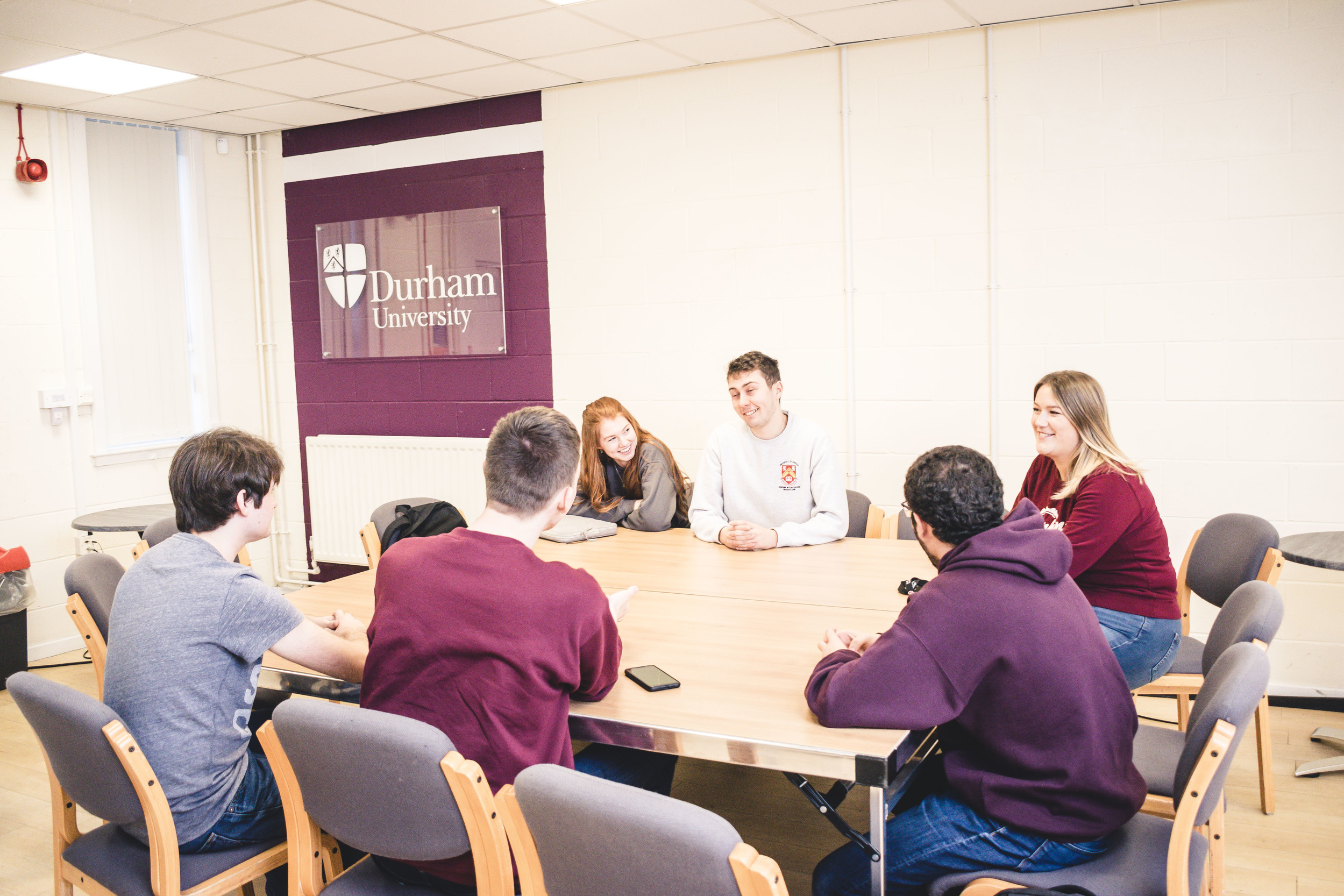 Students sat round a table having a discussion