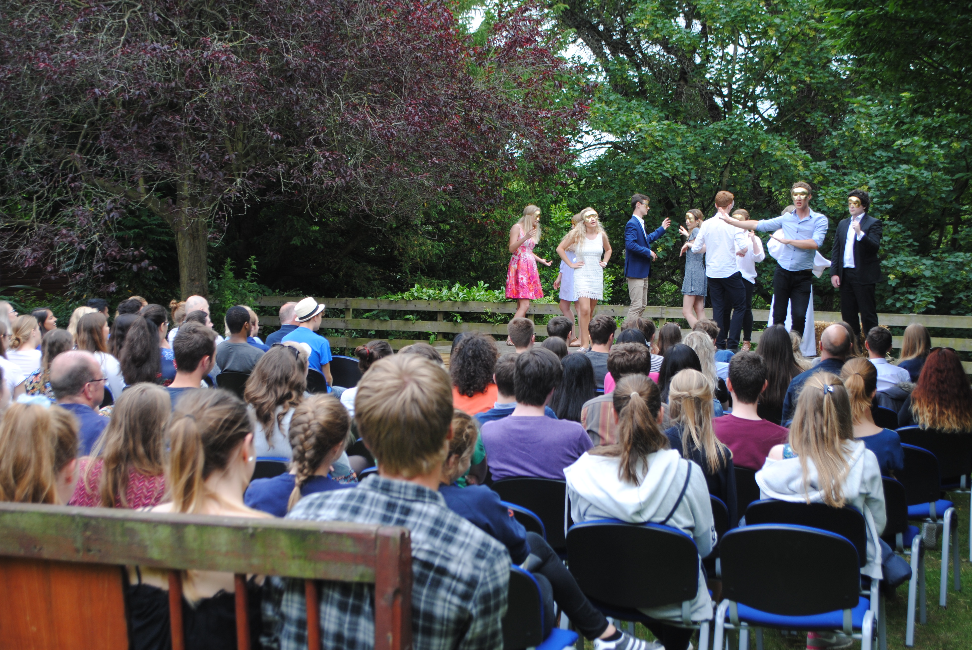 group watching performance on stage